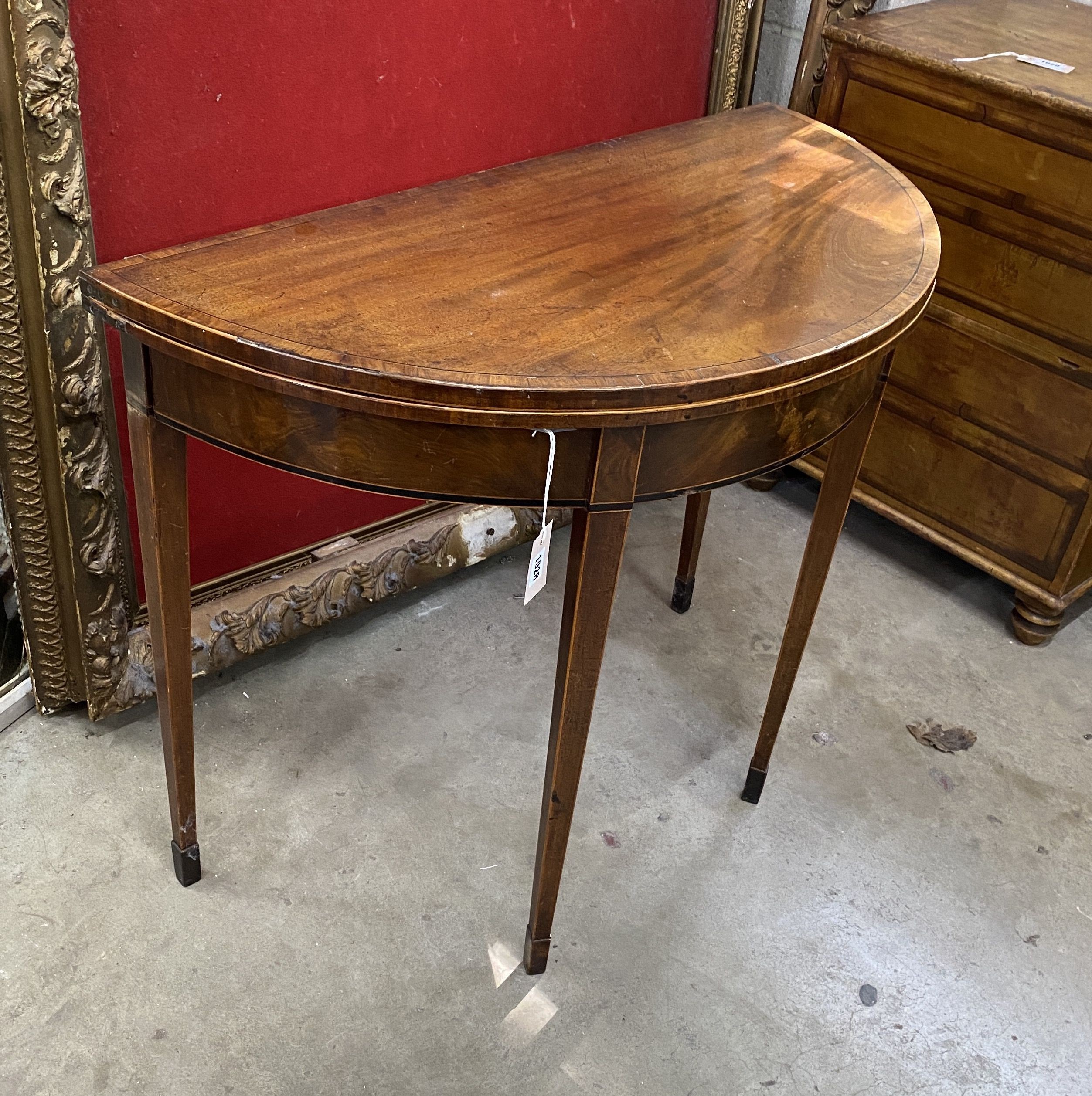 A George III satinwood banded mahogany D shaped folding card table, width 92cm, depth 45cm, height 74cm